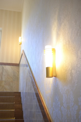 Atmospherically lit staircase with wall decoration